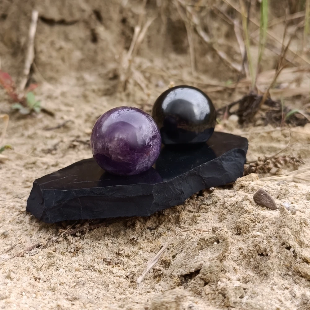 Kugel Harmonieset Schungit und Amethyst auf Sand stehend