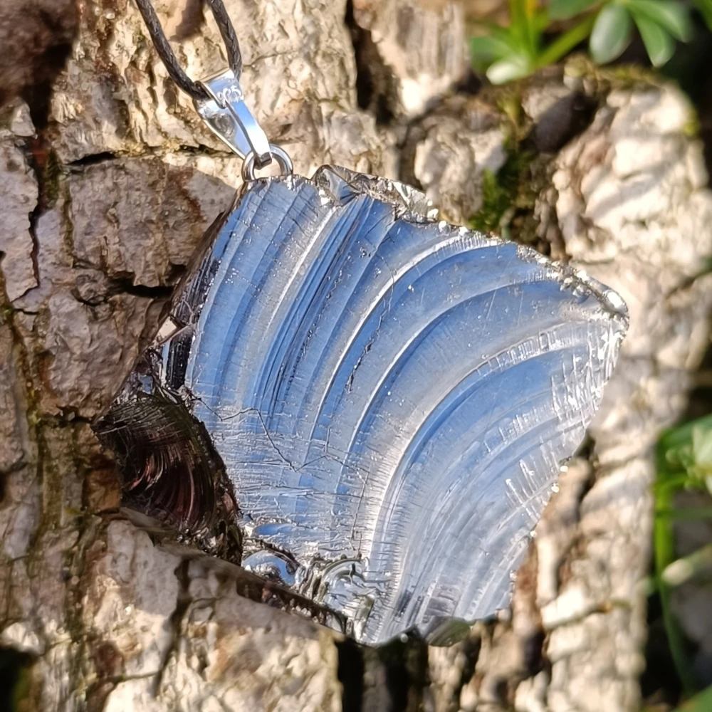 Edel Schungit Anhänger in dreieckiger Form in der Hand
